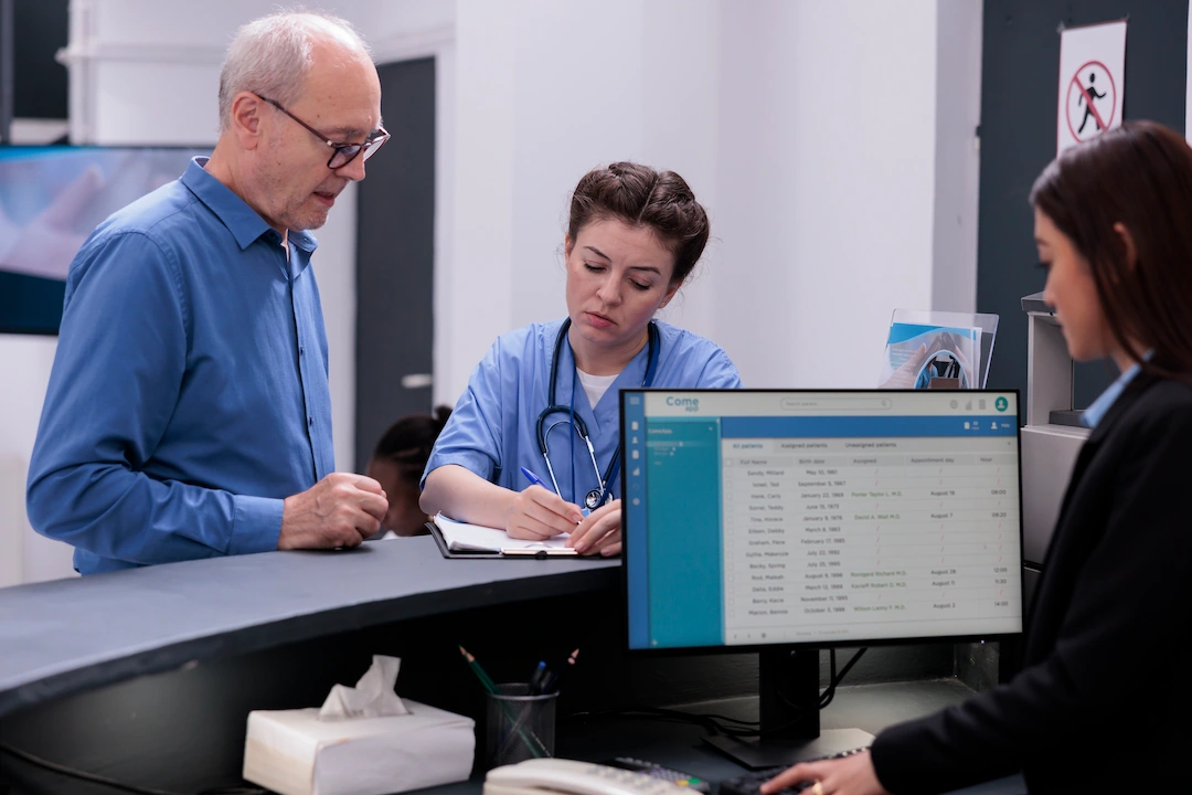 A doctor and receptionist guiding patient about medical billing services and availing services for affordable medical facilities at Bardon medical centre in Brisbane